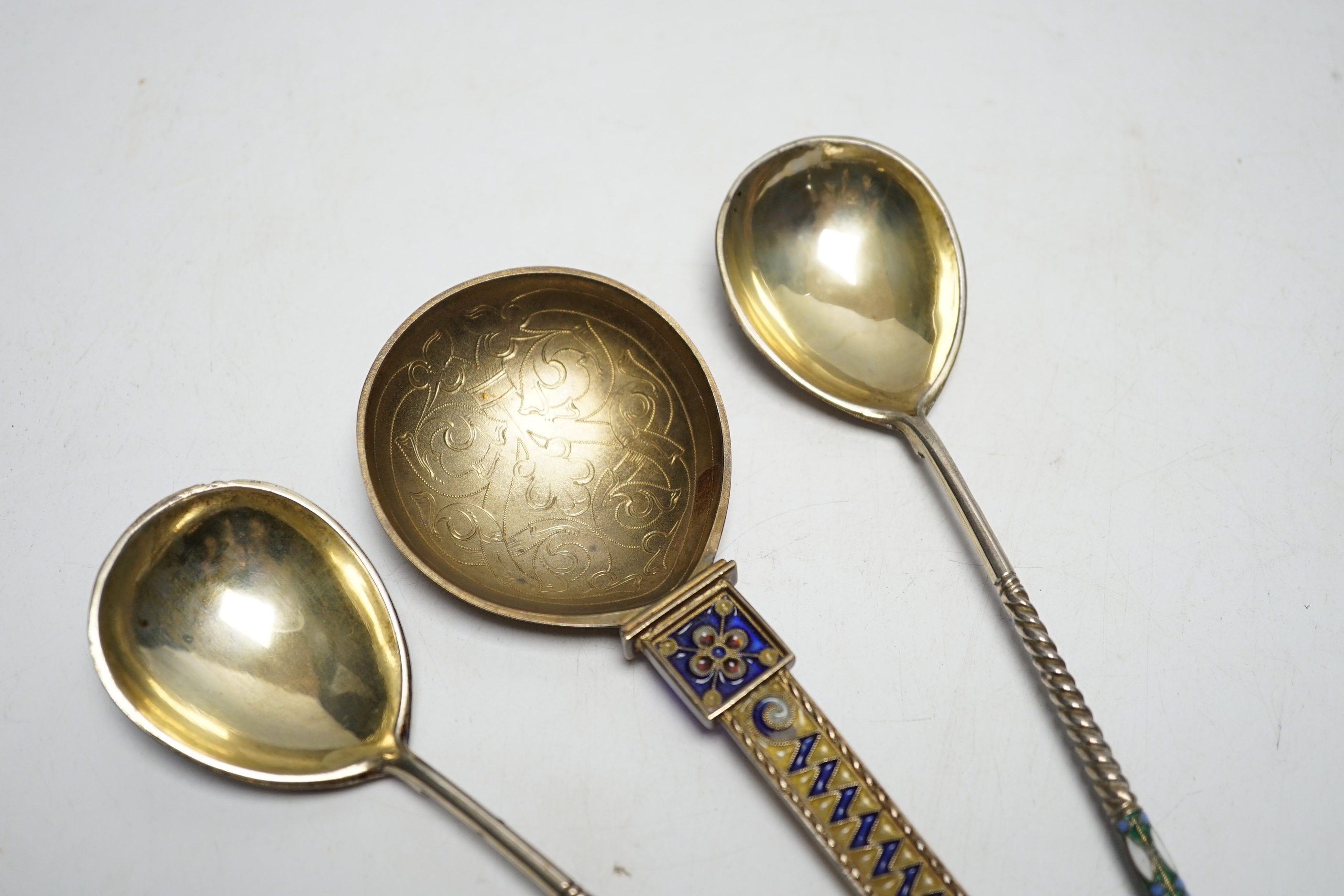 A Norwegian gilt sterling and plique a jour enamelled spoon, 16.2cm (a.f.), together with a pair of late 19th/early 20th century Russian 84 gilt zolotnik and cloisonné enamel spoons.